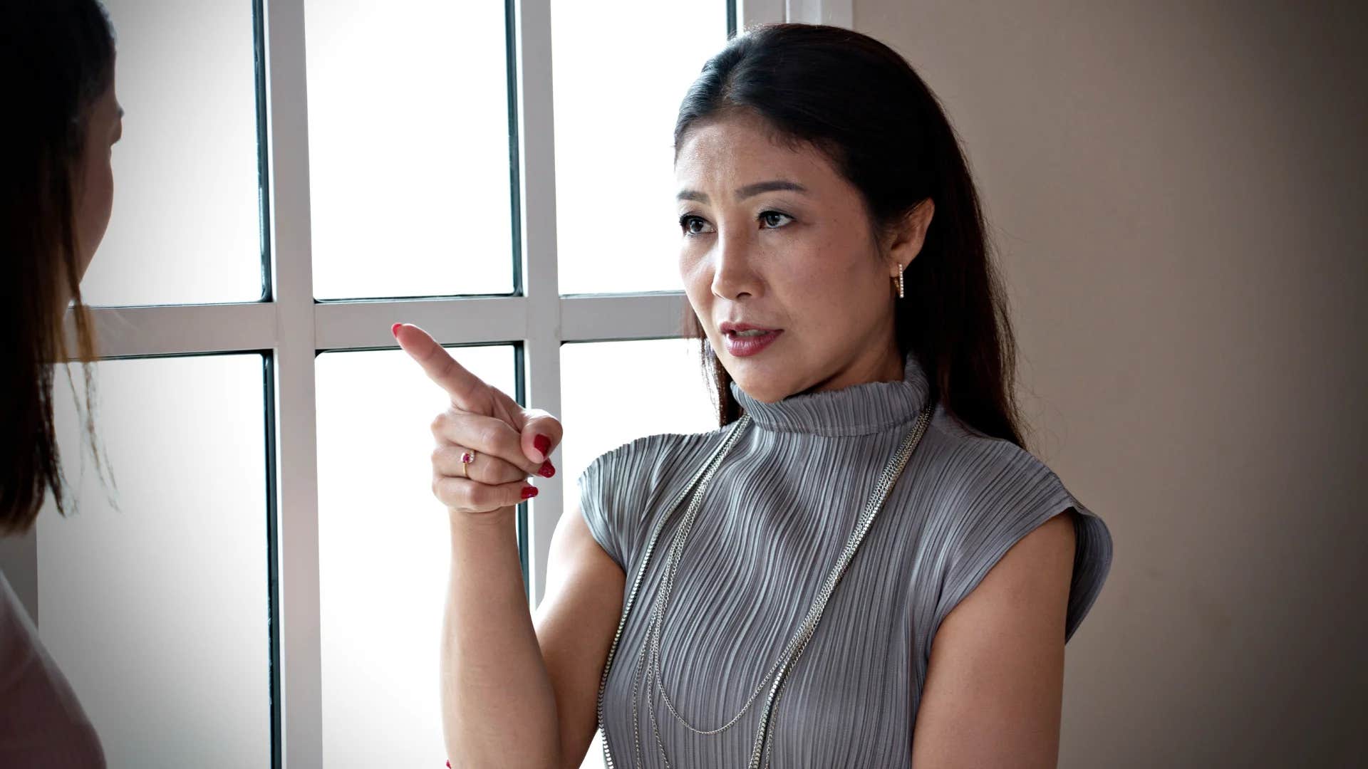 woman confronting colleague saying that's not fair
