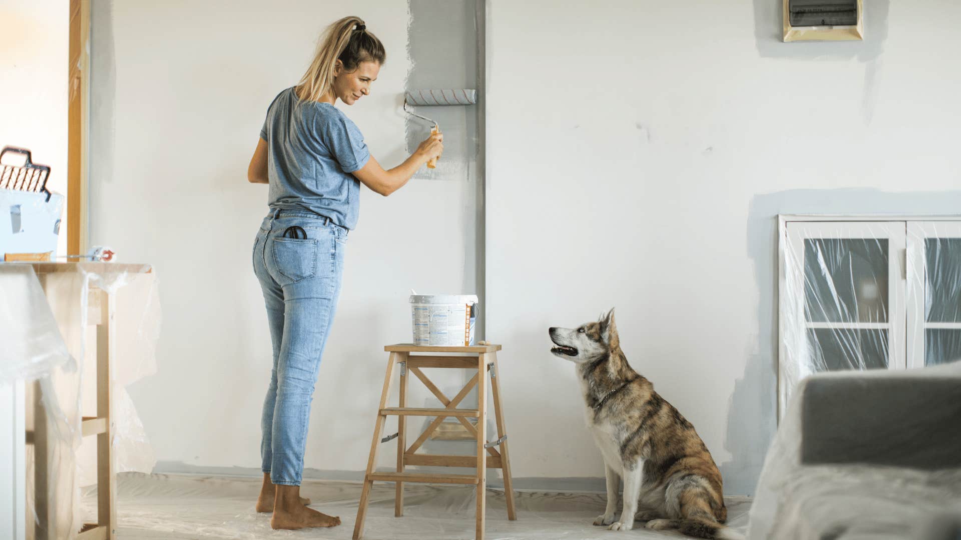woman raised in blue collar home painting her own house