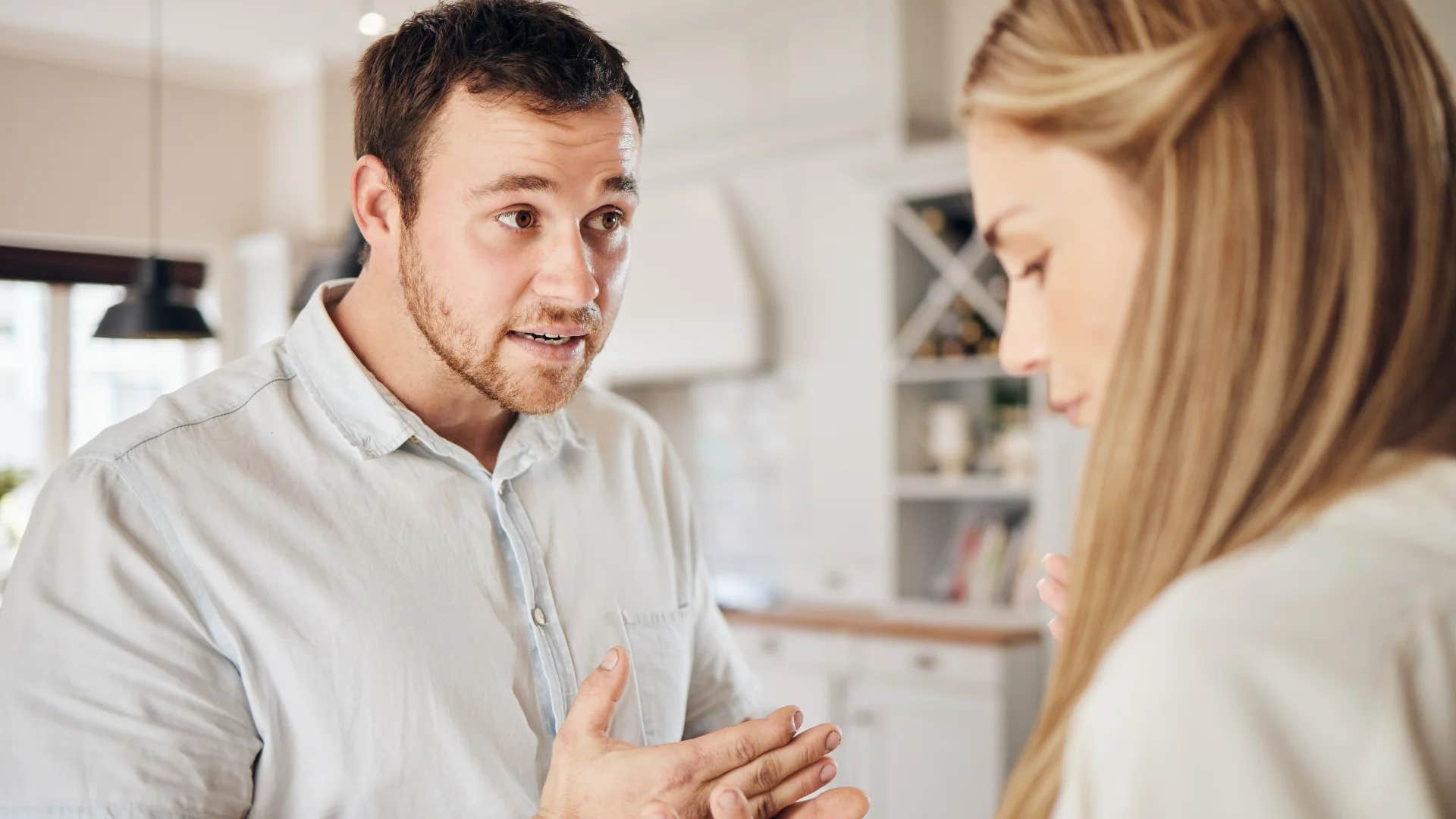 man telling woman that he's still speaking