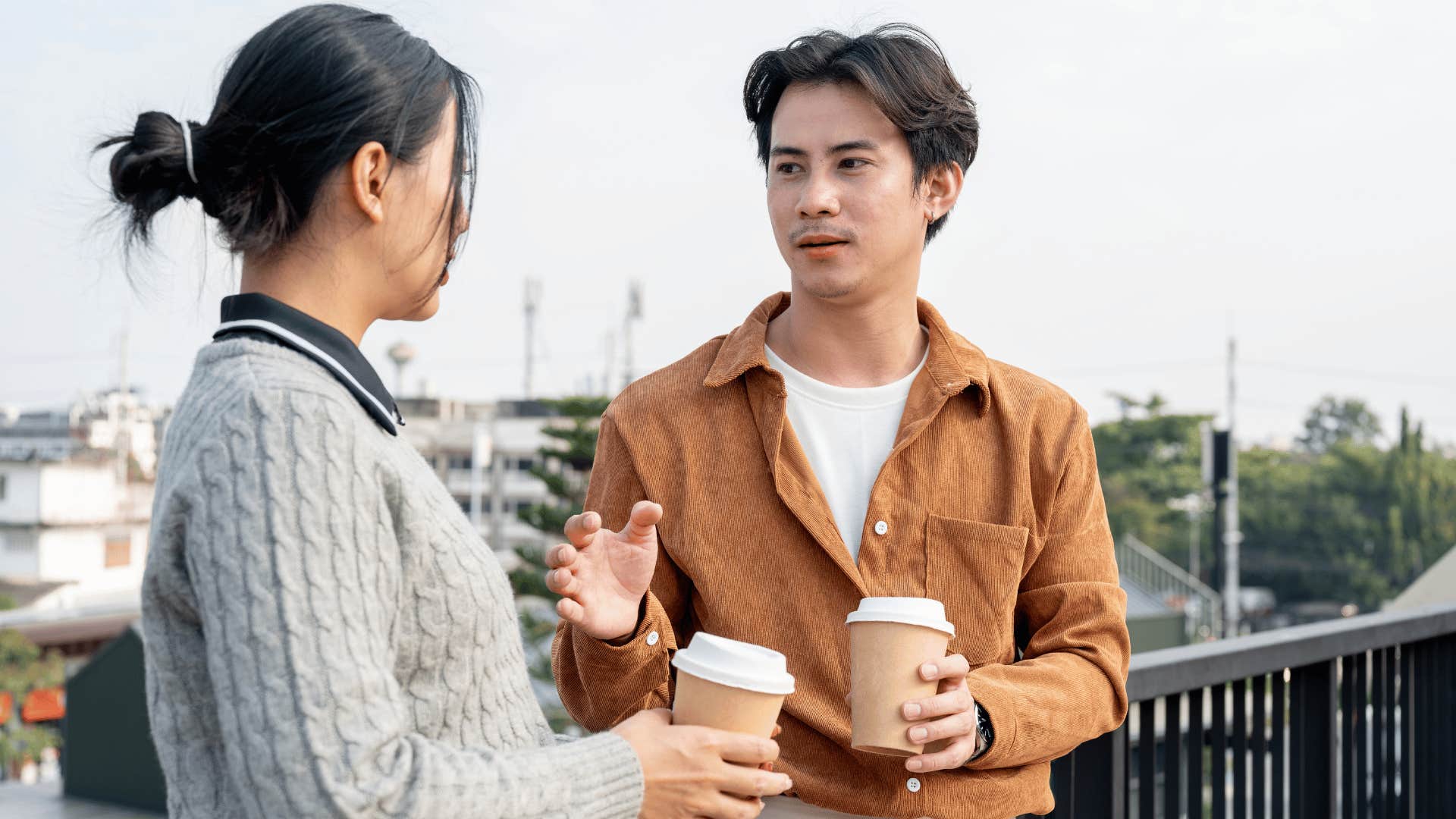 man in white shirt telling woman at some point you have to stop making excuses for people as they chat over coffee