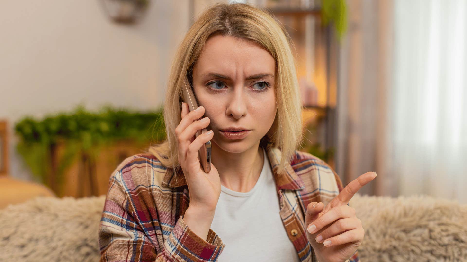 woman in white shirt scolding person on the phone as she says i don't want to hear their side anymore