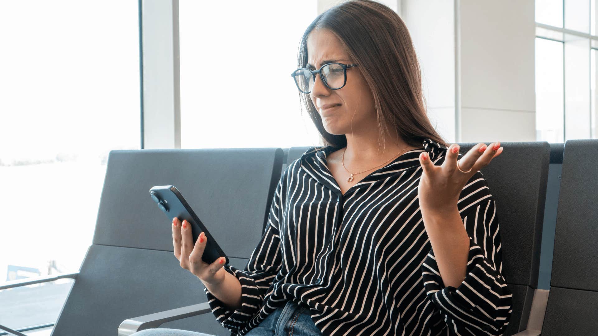woman in black shirt and glasses looking at phone upset as she says i'm tired of being the bigger person