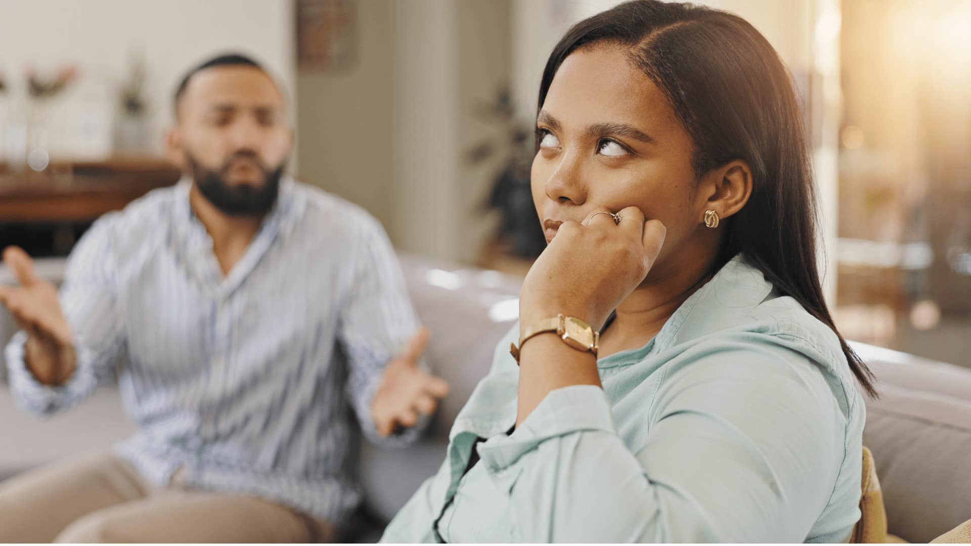 woman rolling her eyes at man as she says it's fine