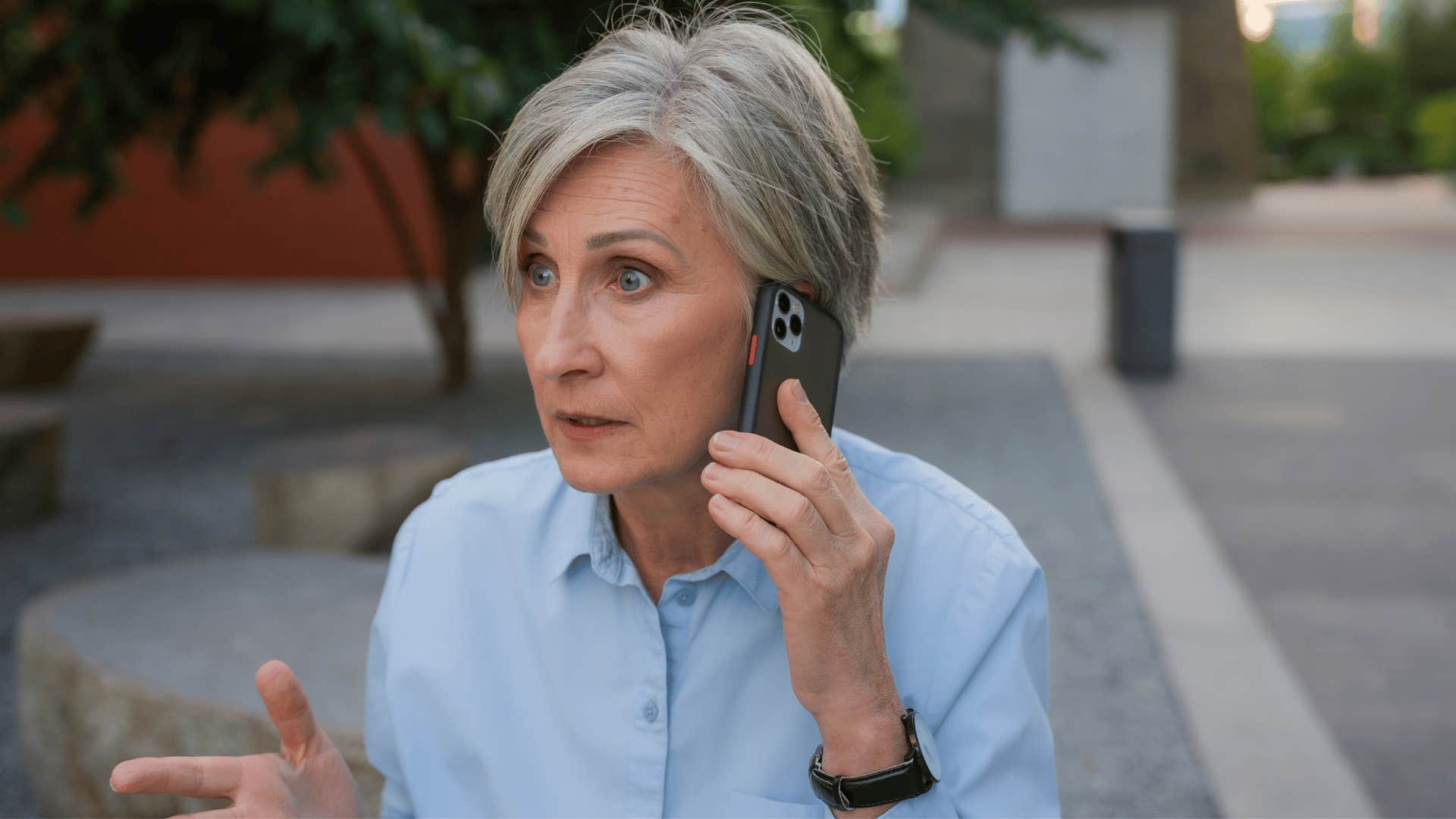 woman in blue shirt on the phone saying i don't have the patience for this