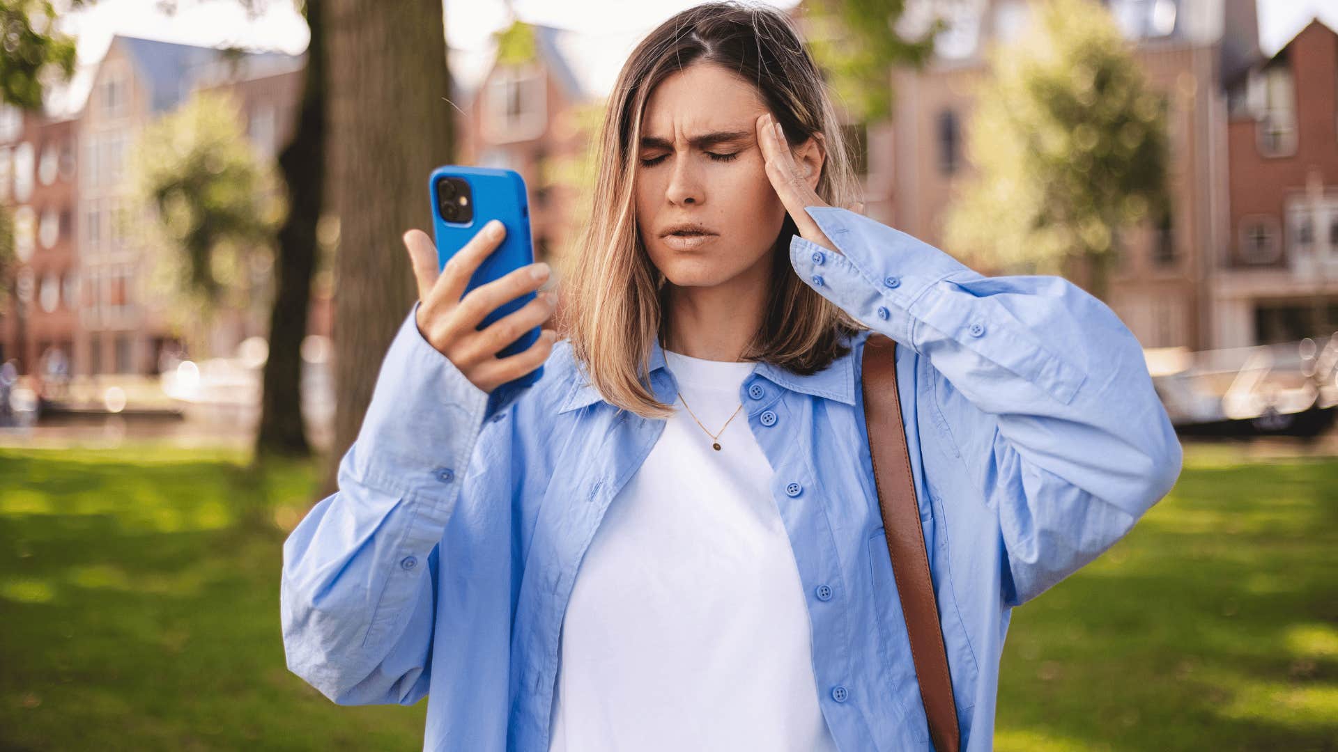woman groaning internally as she stares at phone and thinks some people just don't listen