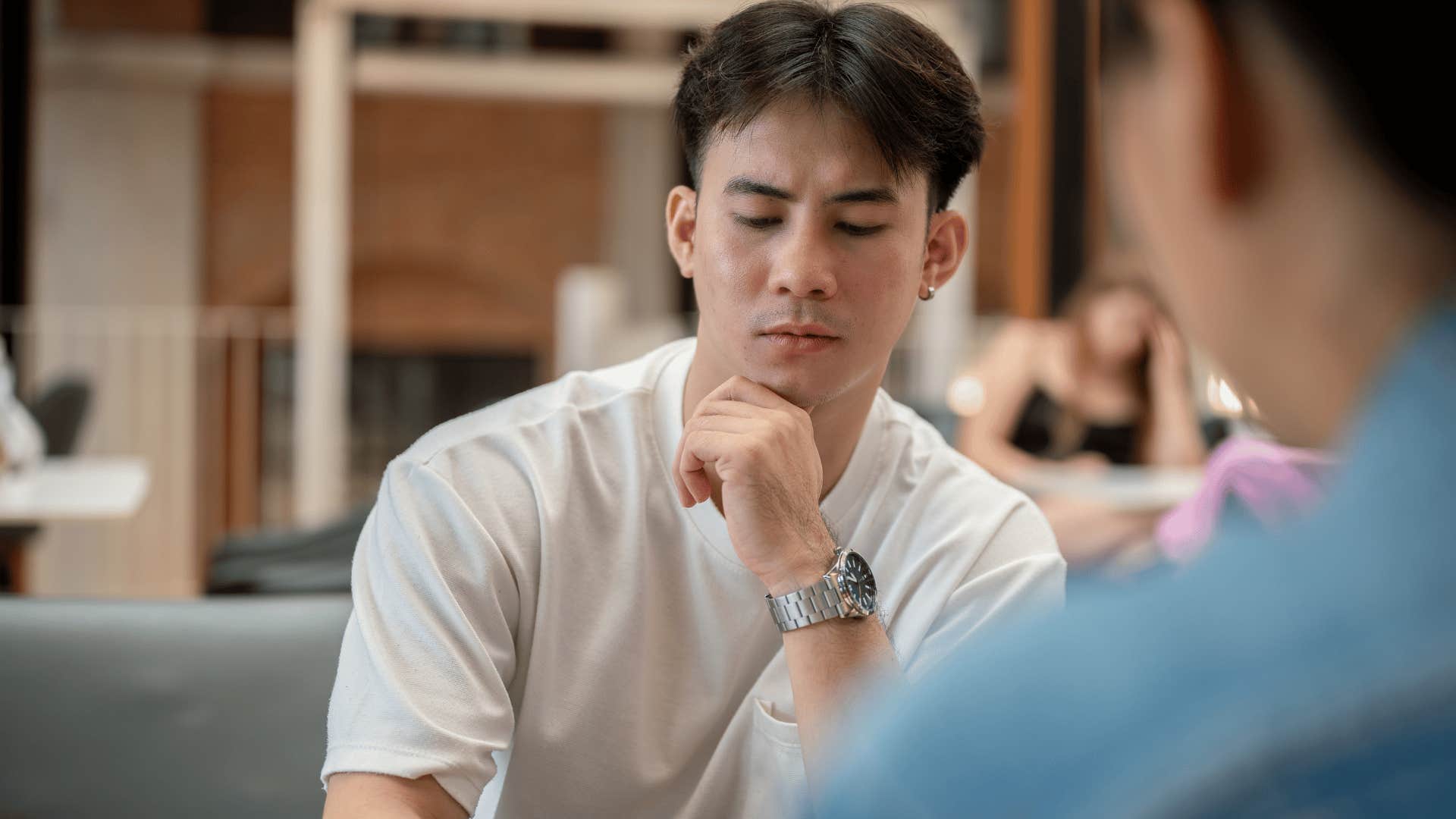 man in white shirt looking down as he says it's nice i guess