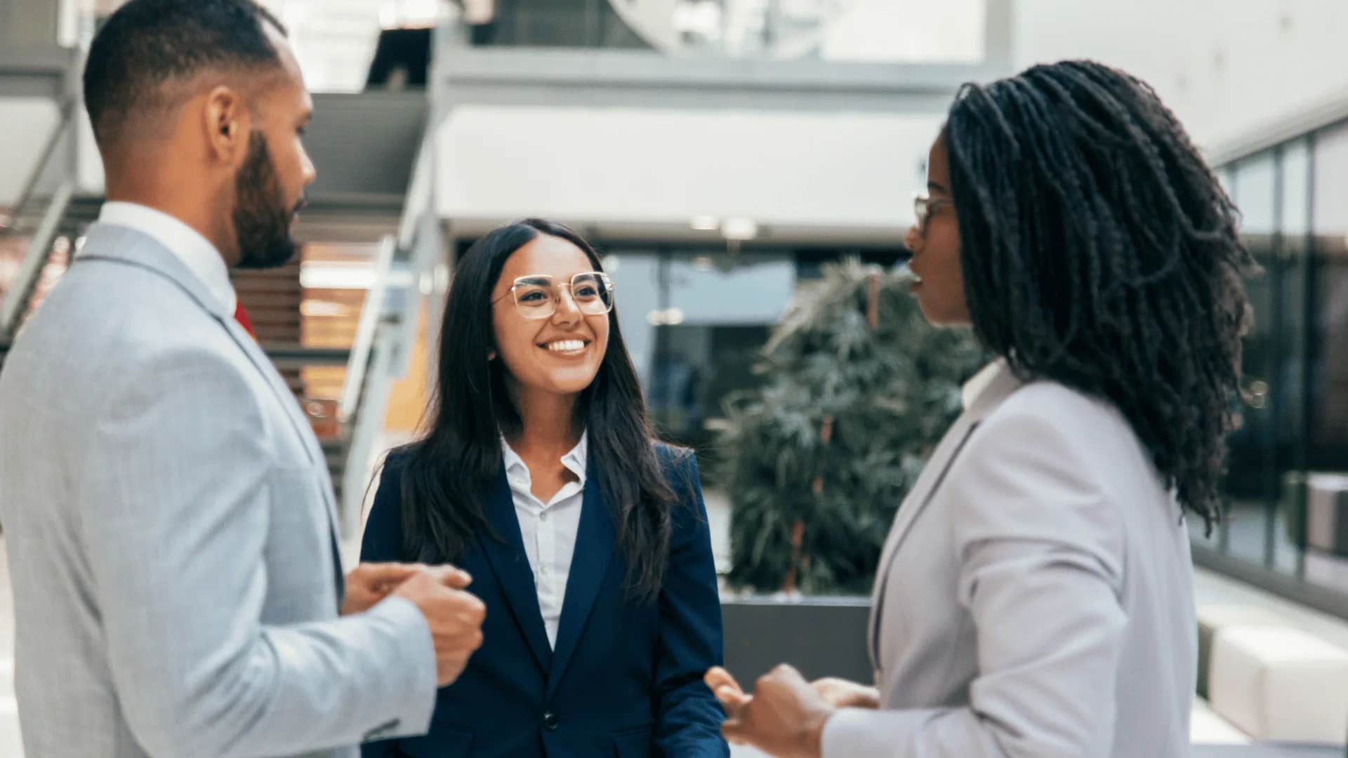 smiling woman telling colleagues this is a win-win situation