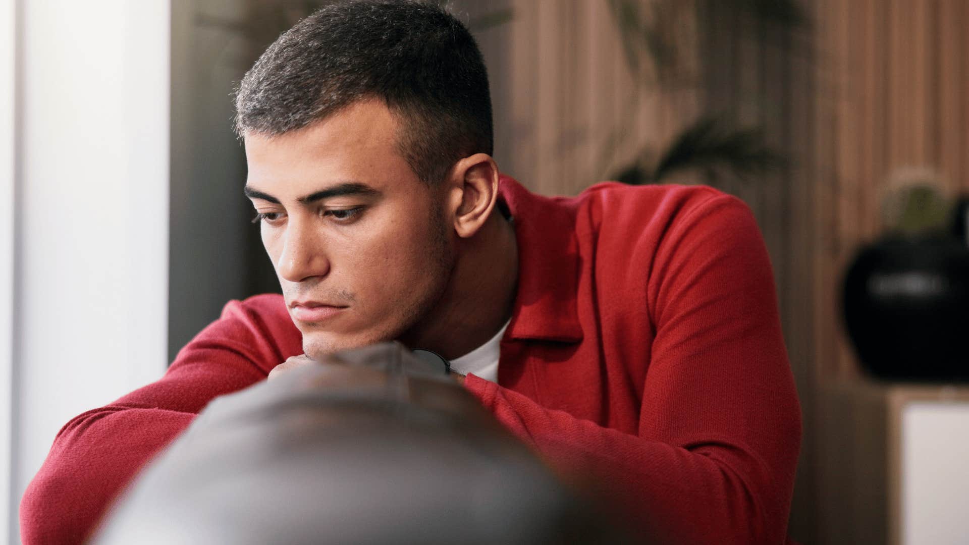 man in red shirt on the couch as he thinks i haven't been myself lately