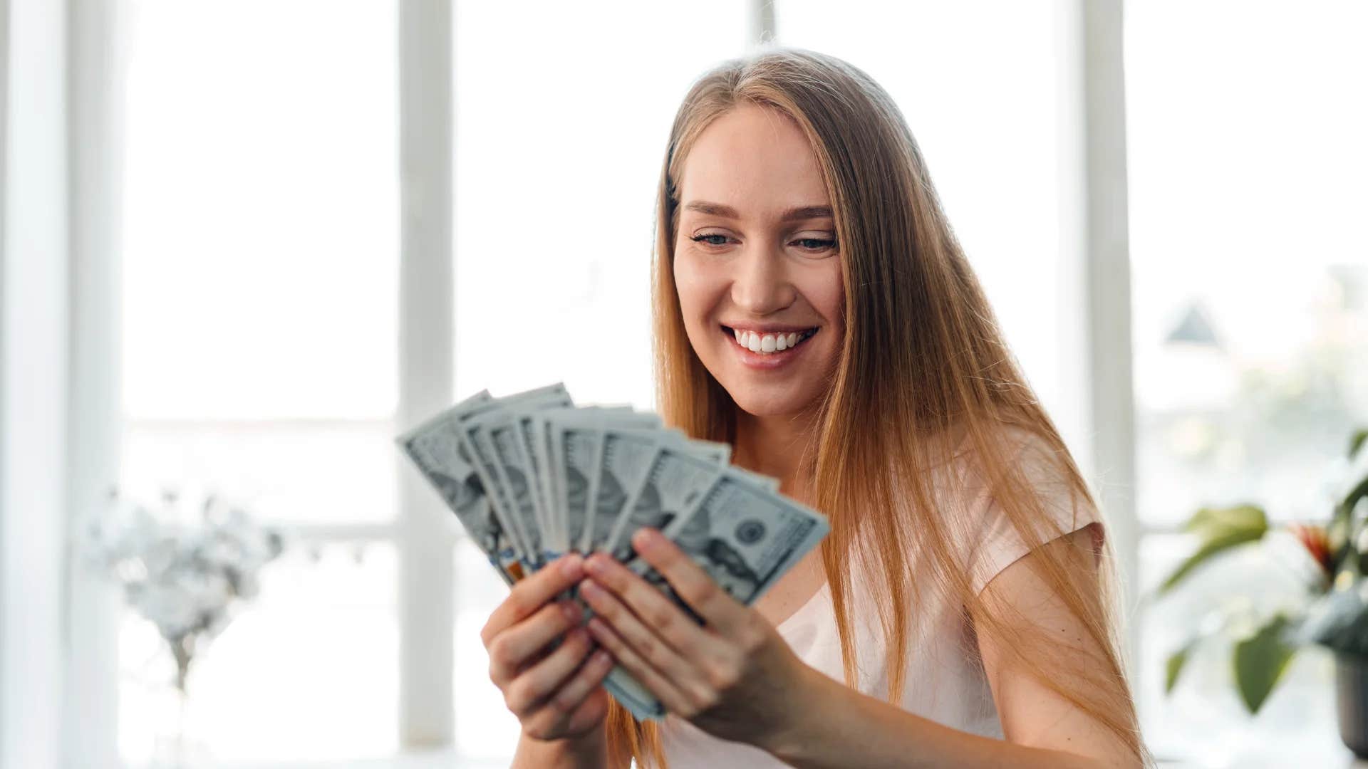privileged woman holding money to make her happy