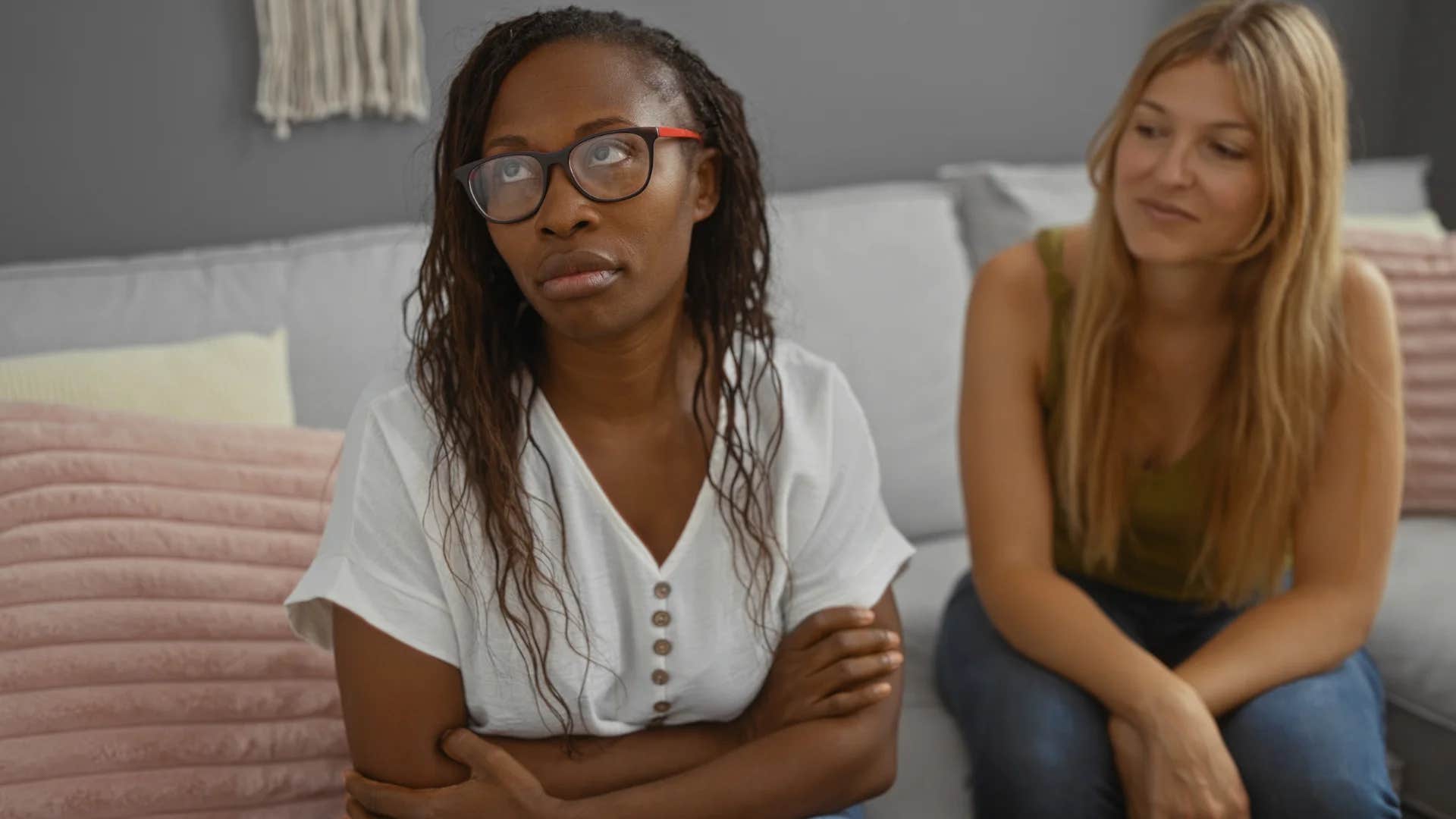 woman rolling her eyes at privileged friend telling her to try harder