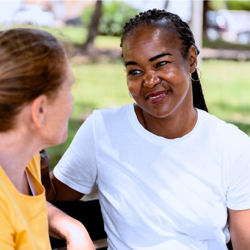 observant woman considering the bigger picture talking to friend
