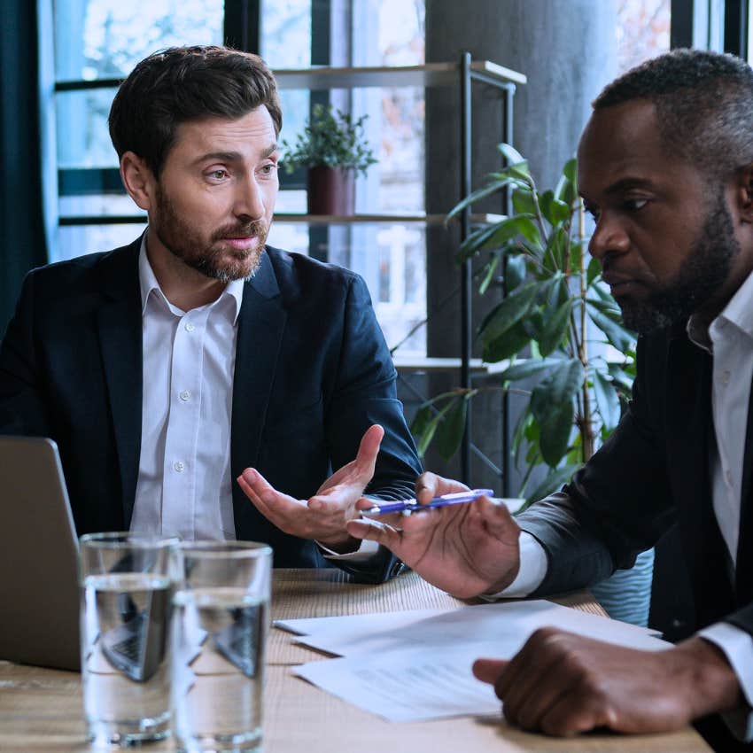 stressed man asking colleague who's taking ownership of that at work