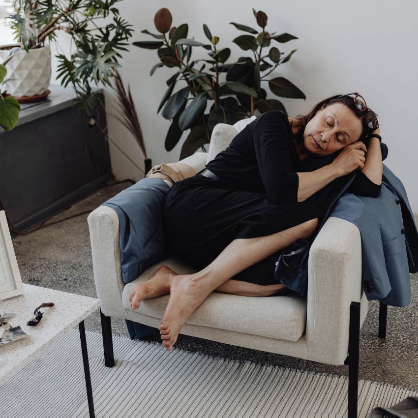 mentally and emotionally drained woman collapsing on the couch after work