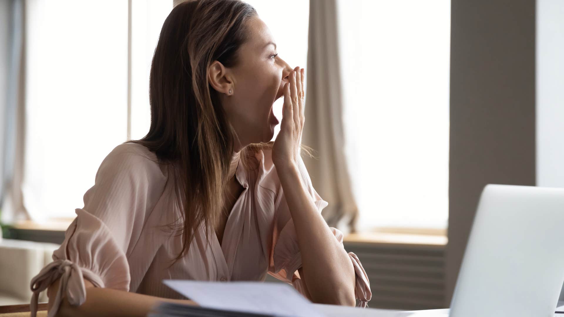 woman yawning because she's too tired to have fun