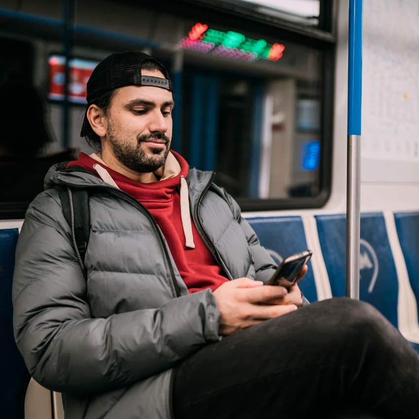 Man who can go out alone looking at his phone in public.