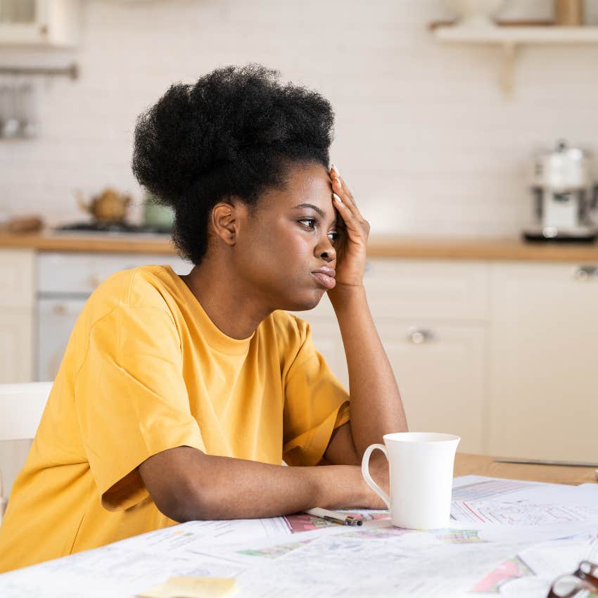 exhausted woman at the kitchen table