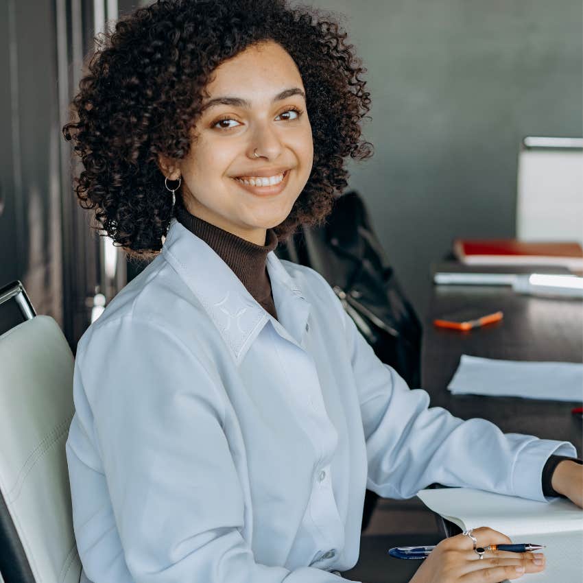 happy professional woman smiling at her desk