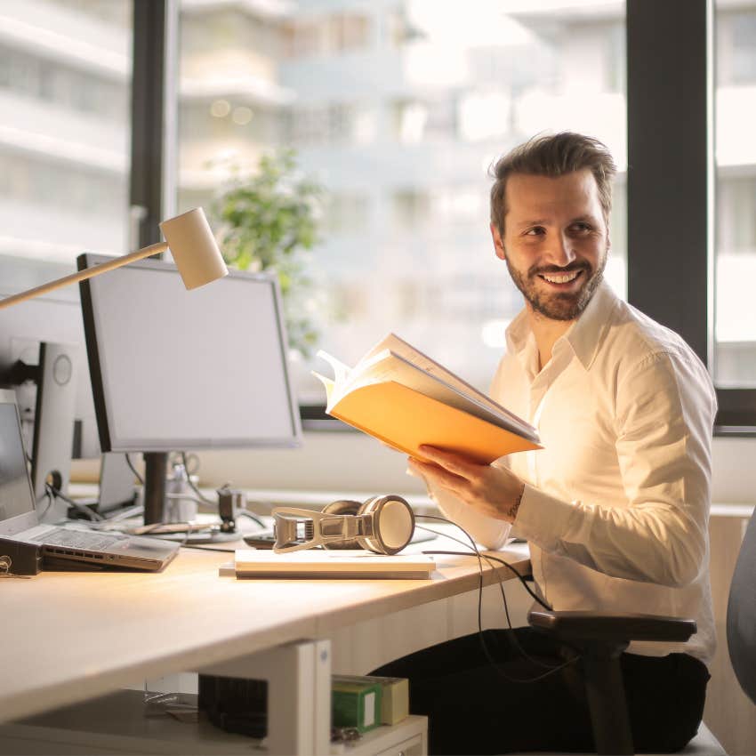 confident man smiling at work feeling fulfilled and comfortable