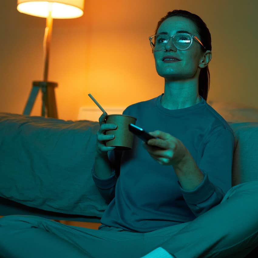 woman with flexible schedule sitting on the couch watching tv