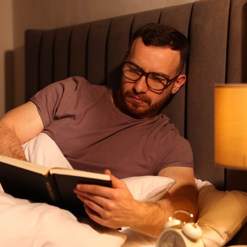 man reading in bed needing comfort to focus