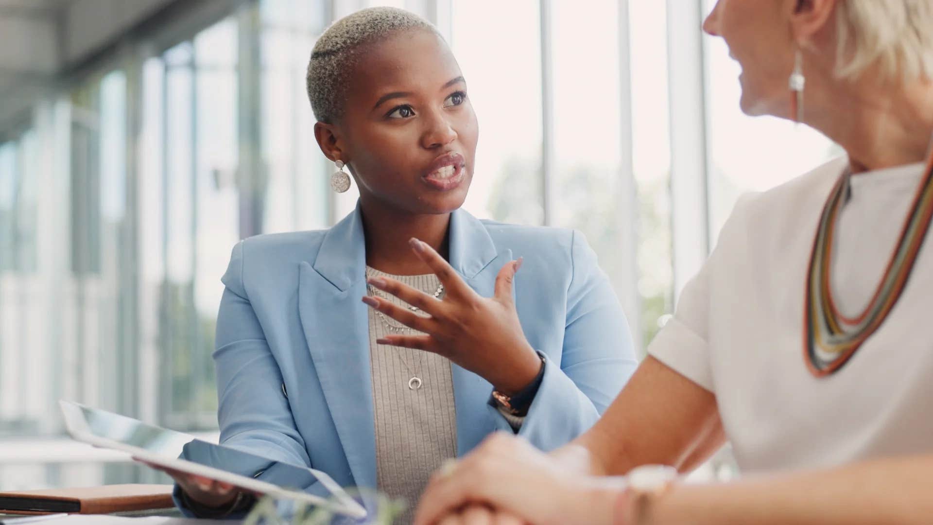 woman telling colleague you've always done great work but lately you seem preoccupied