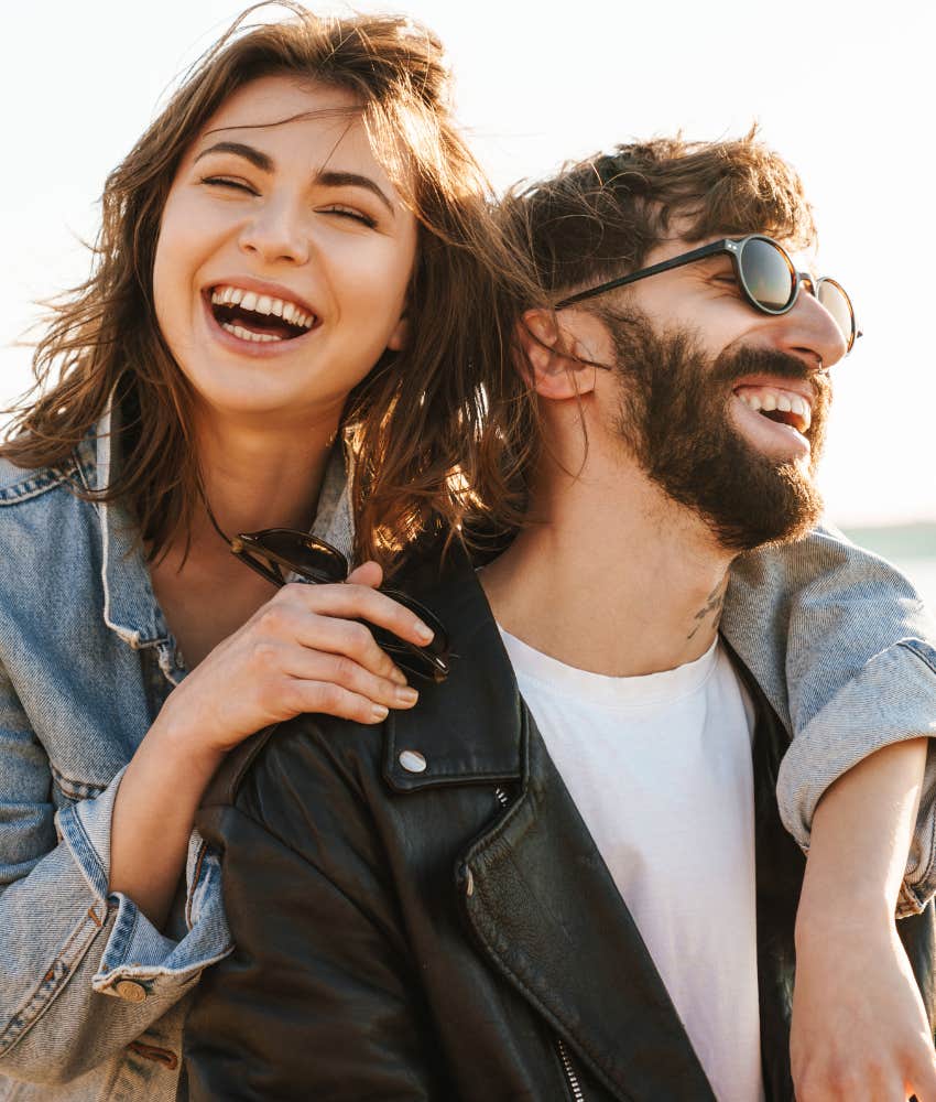 Couple laughing in a childlike and carefree manner