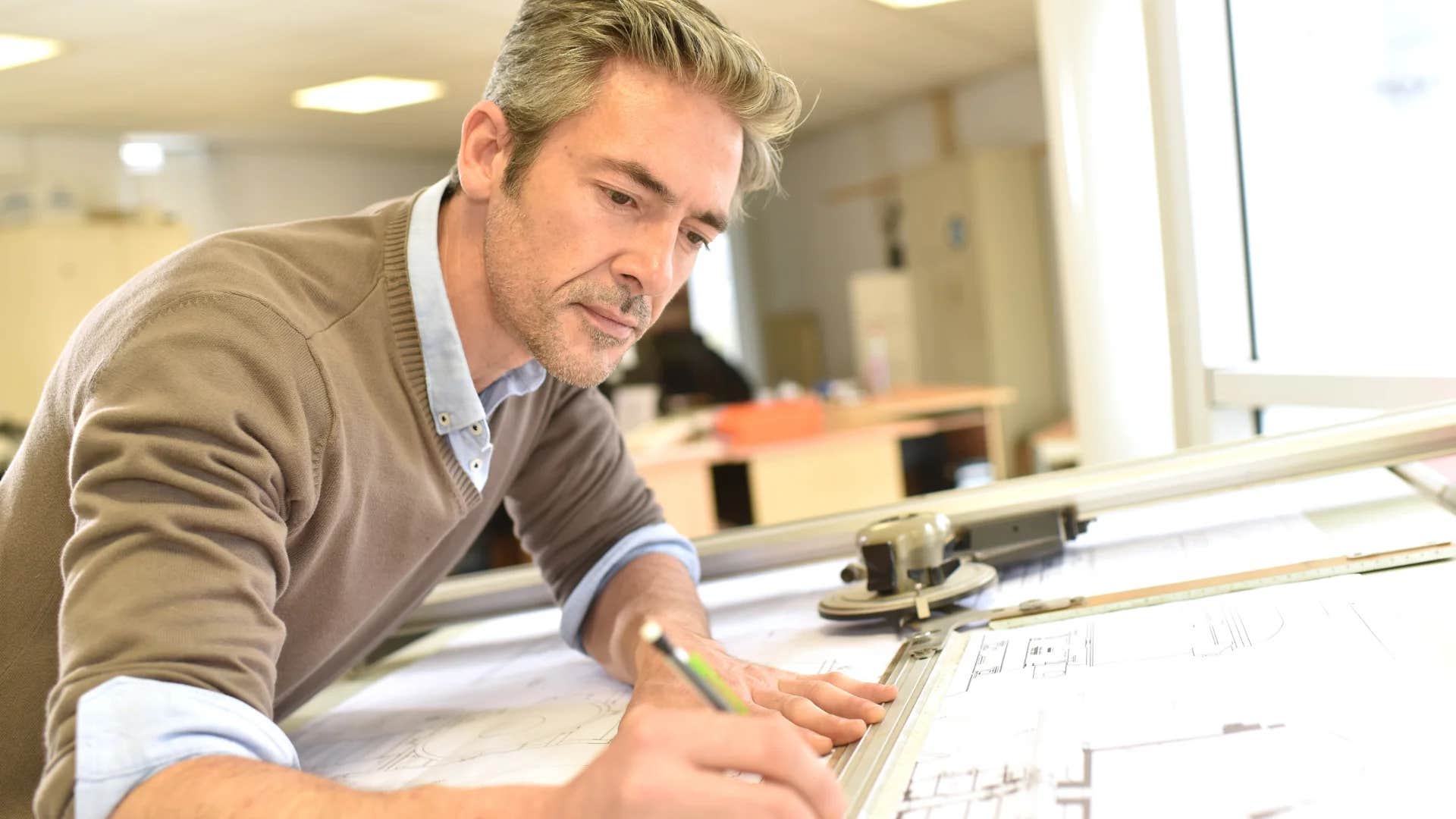 cartographer drawing maps at work