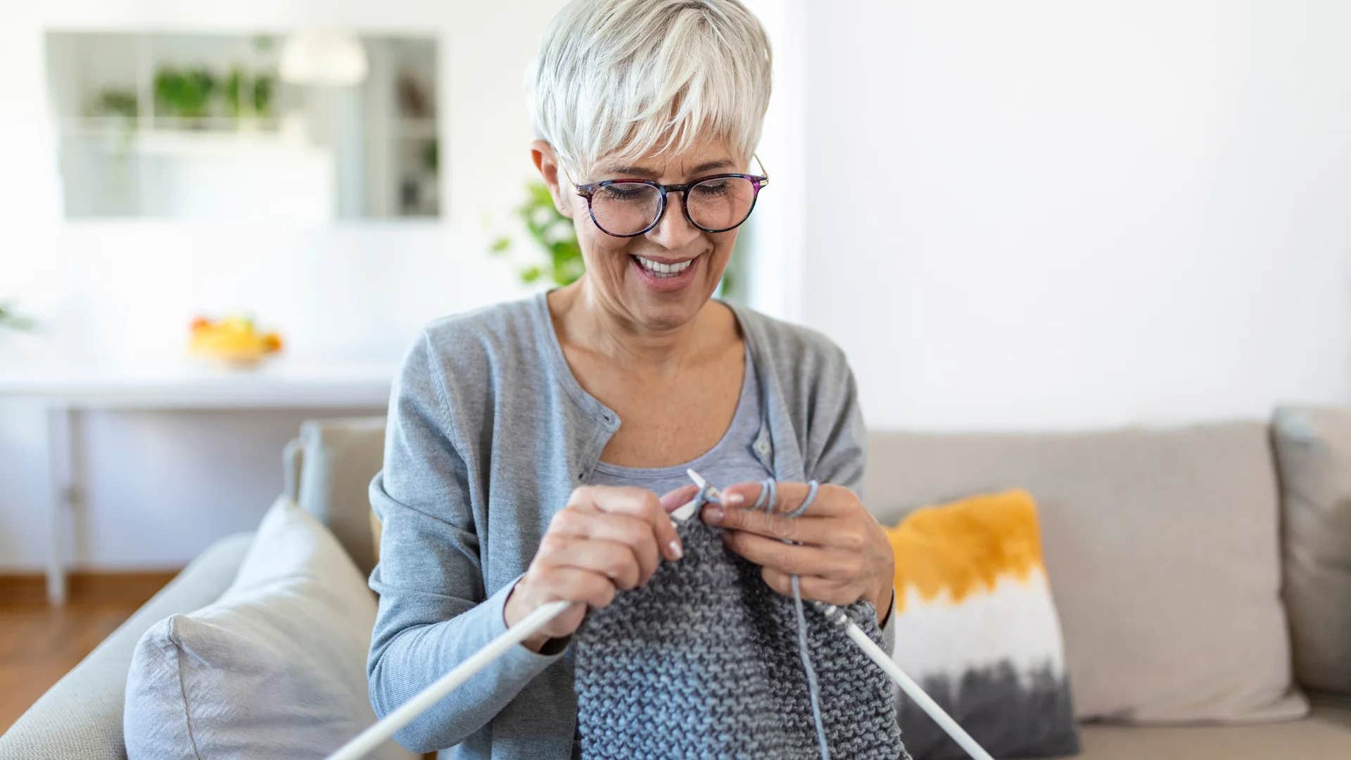 creative woman who feels like an outcast knitting at home