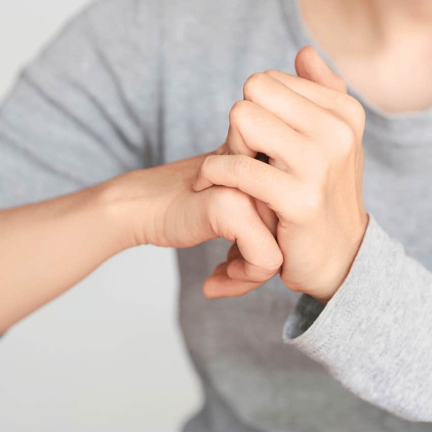 person's hands cracking their knuckles