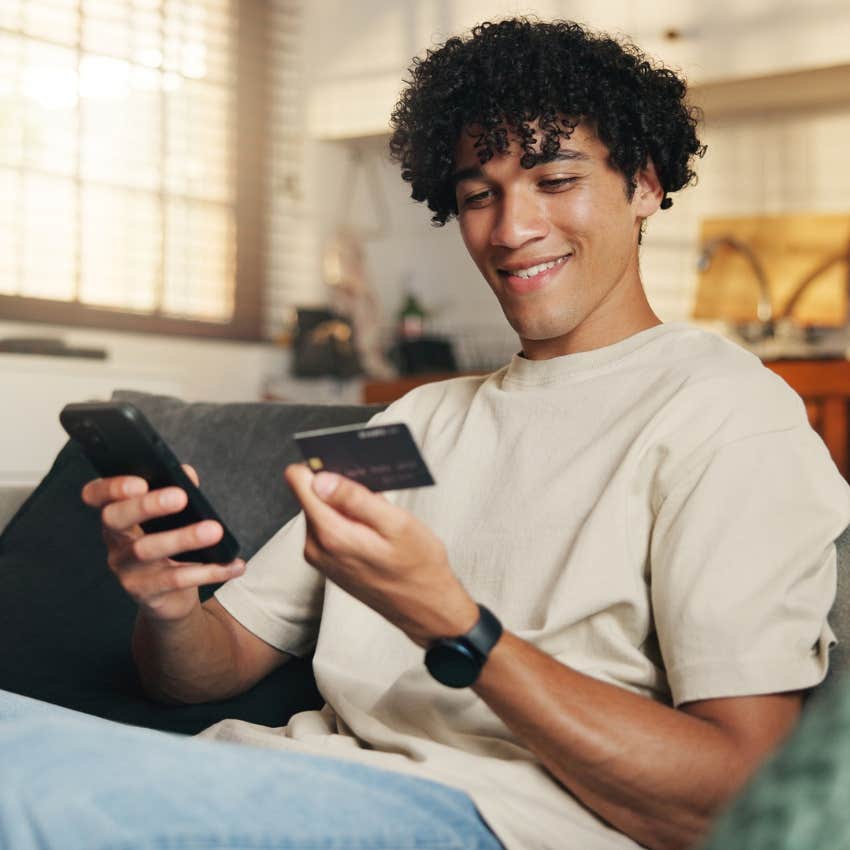 young adult man using a credit card to buy things he can't afford because his parents will bail him out