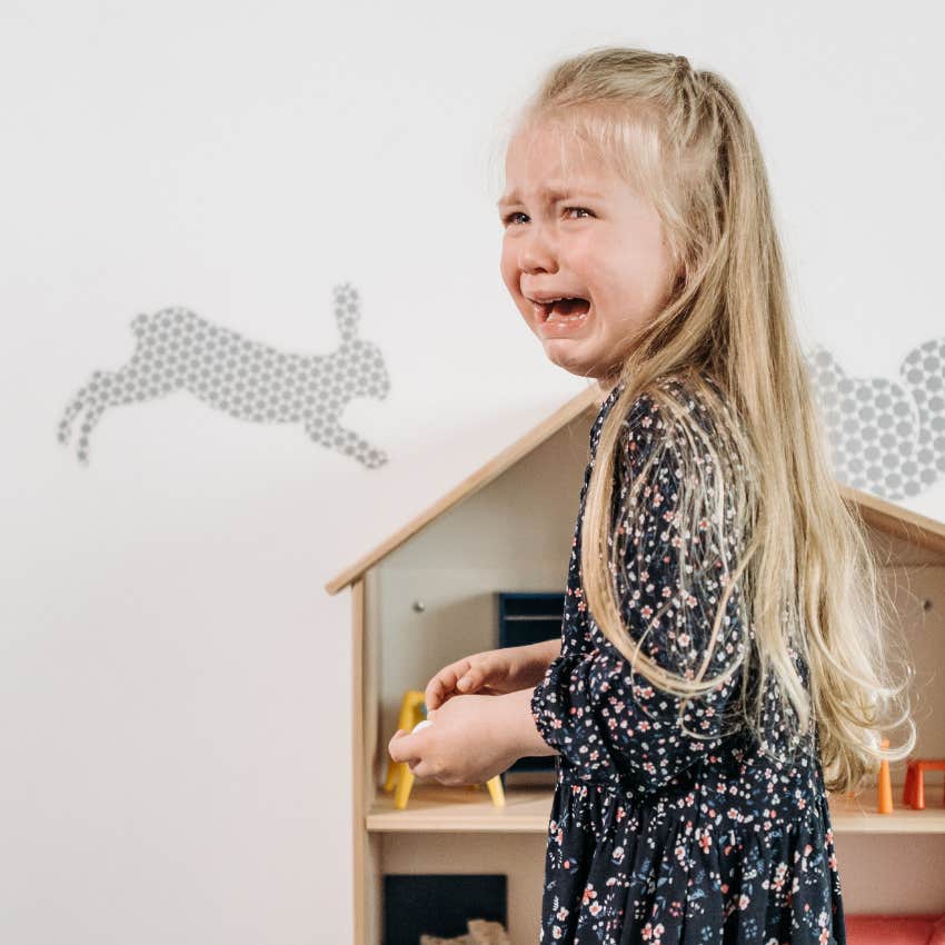 little girl crying asking parent if they're upset with her