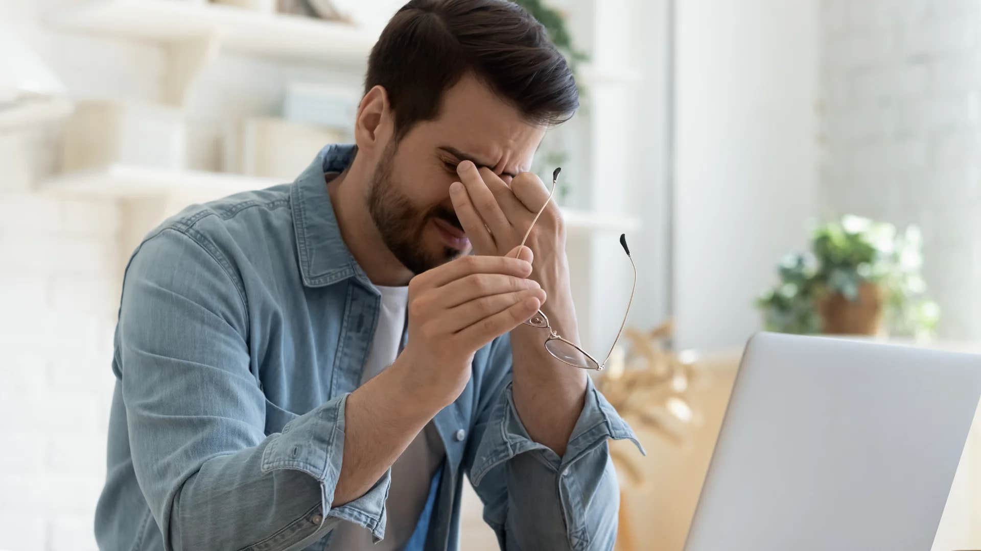 stressed man working on laptop saying i'm stuck