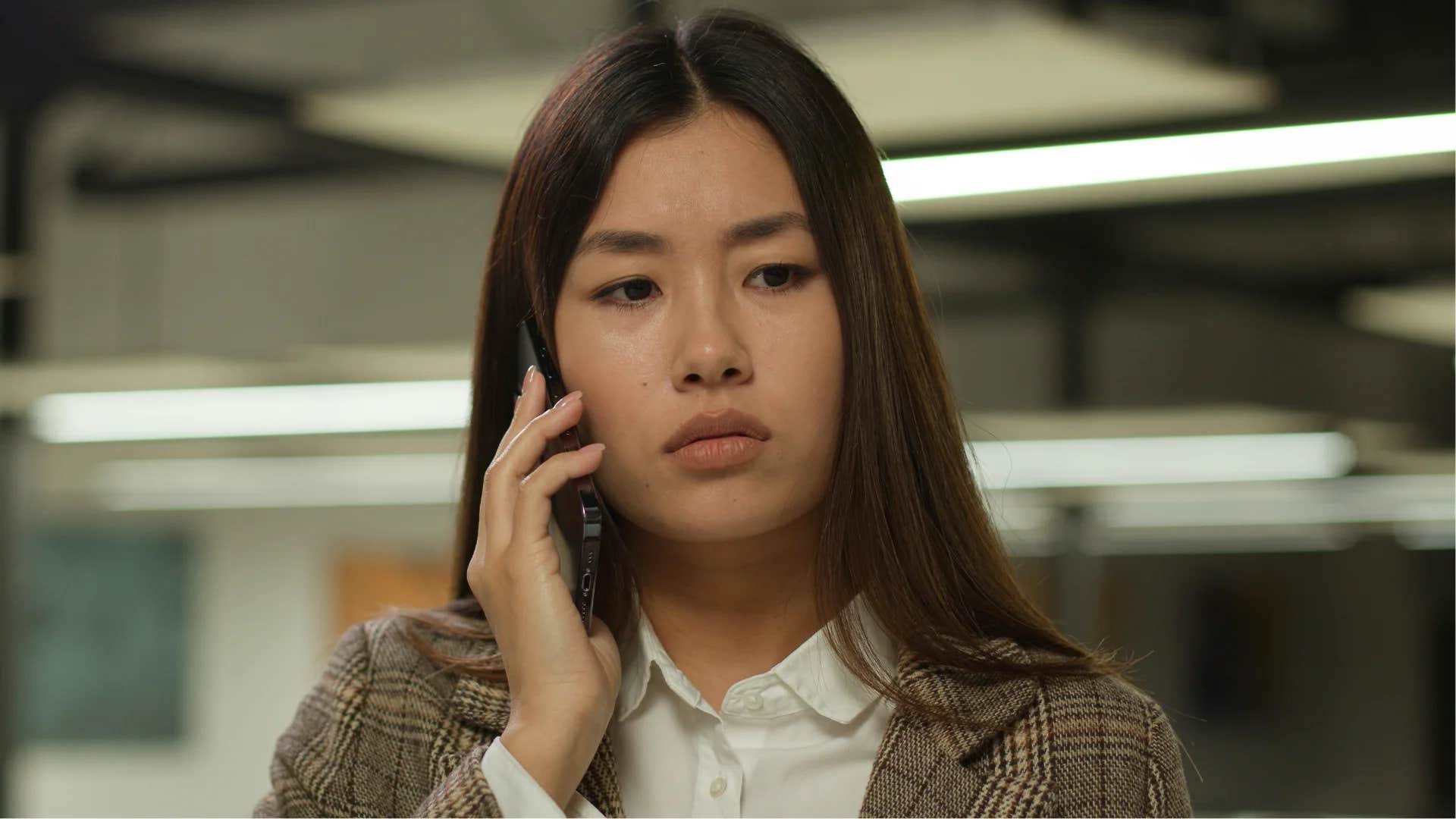 stressed woman on the phone telling colleague it's impossible