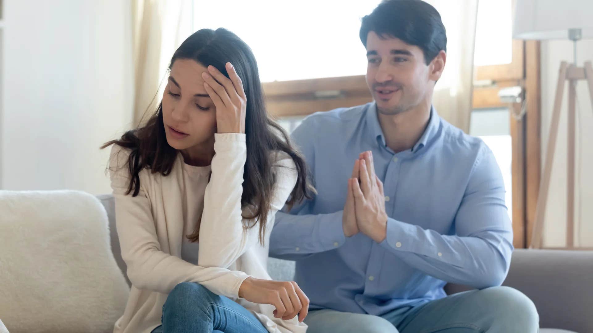 frustrated woman turned away from partner telling him you're better at this