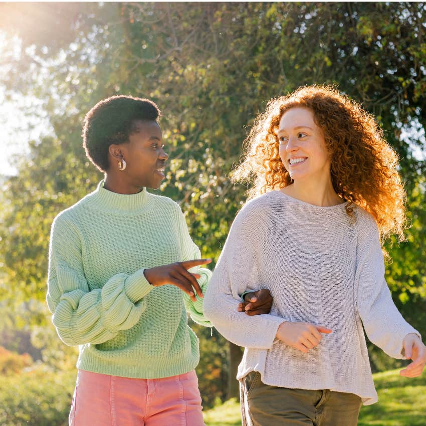 woman with a big heart walking with friend asking if they can talk about something less dramatic