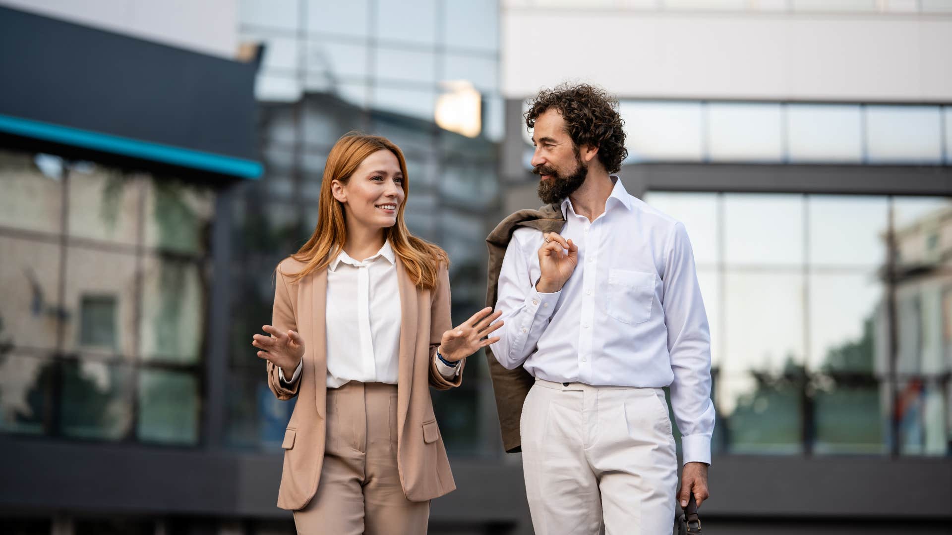 woman who hates small talk walking with co-worker telling him she'll follow up soon