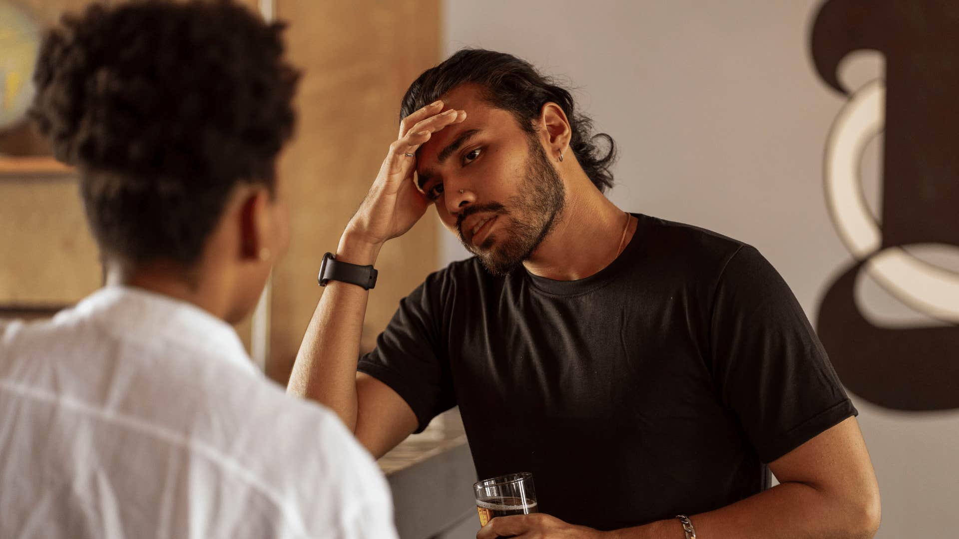 man with low mental and emotional energy saying he's not sure to friend in conversation