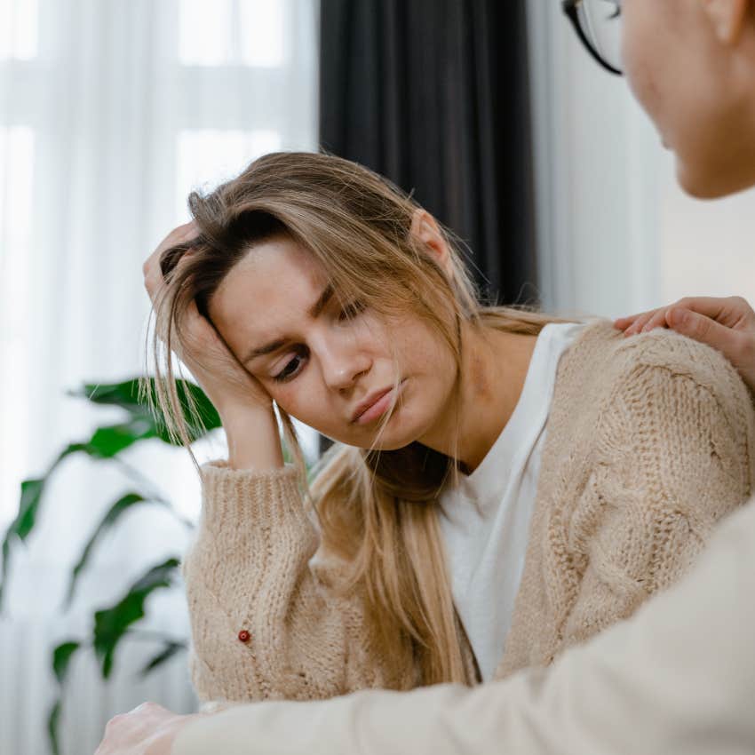 upset woman being comforted by friend after saying i'm drowning