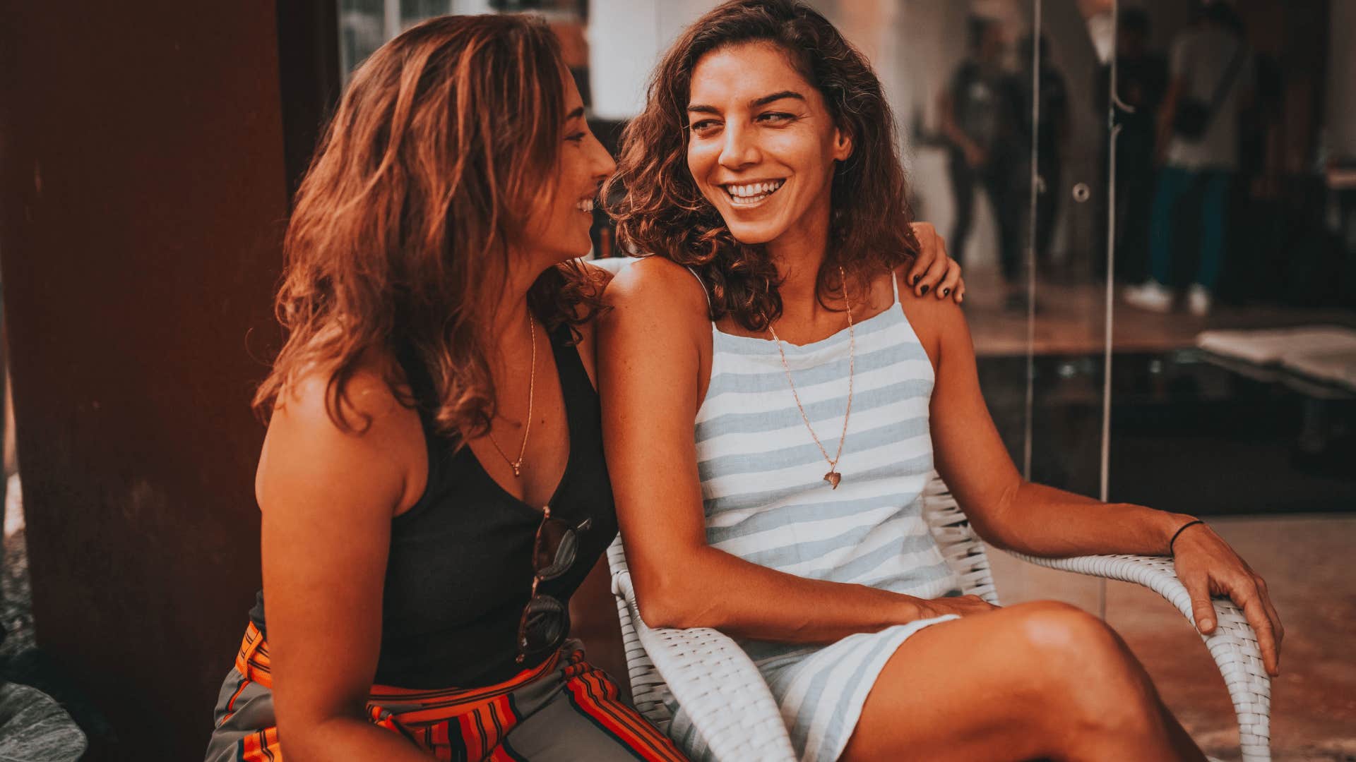 two women smiling happily in conversation