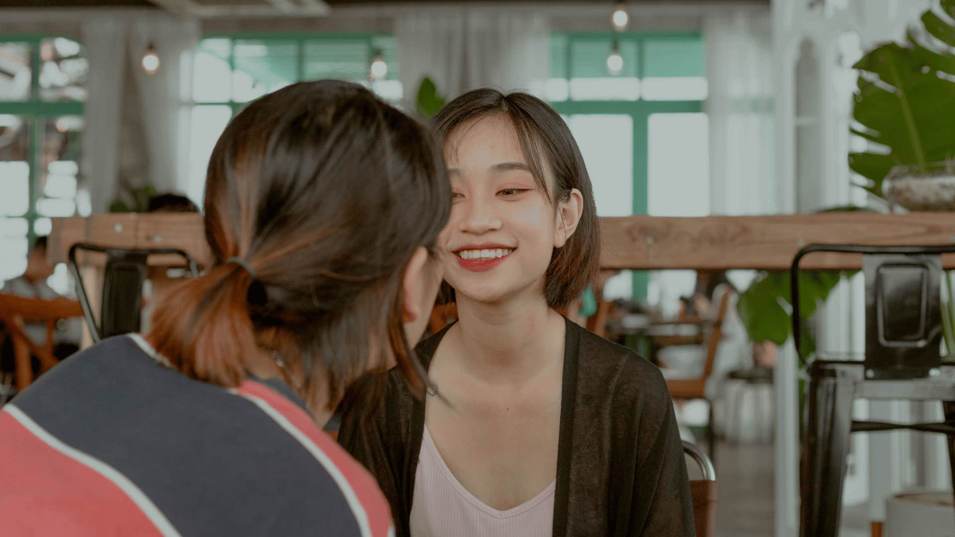 unforgettable young woman talking to colleague looking interested in conversation