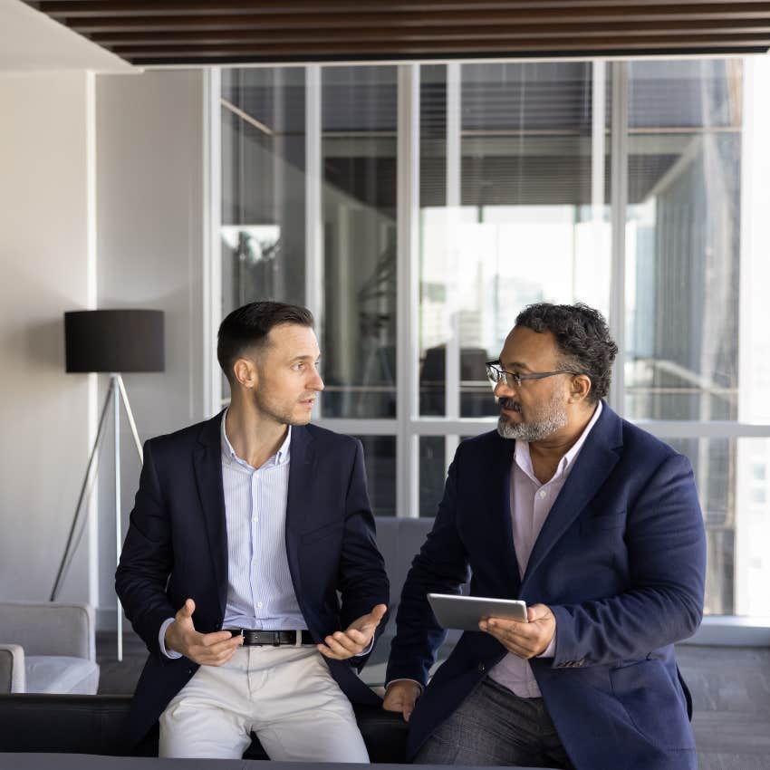 man who is good at solving problems telling co-worker holding tablet let's go over next steps