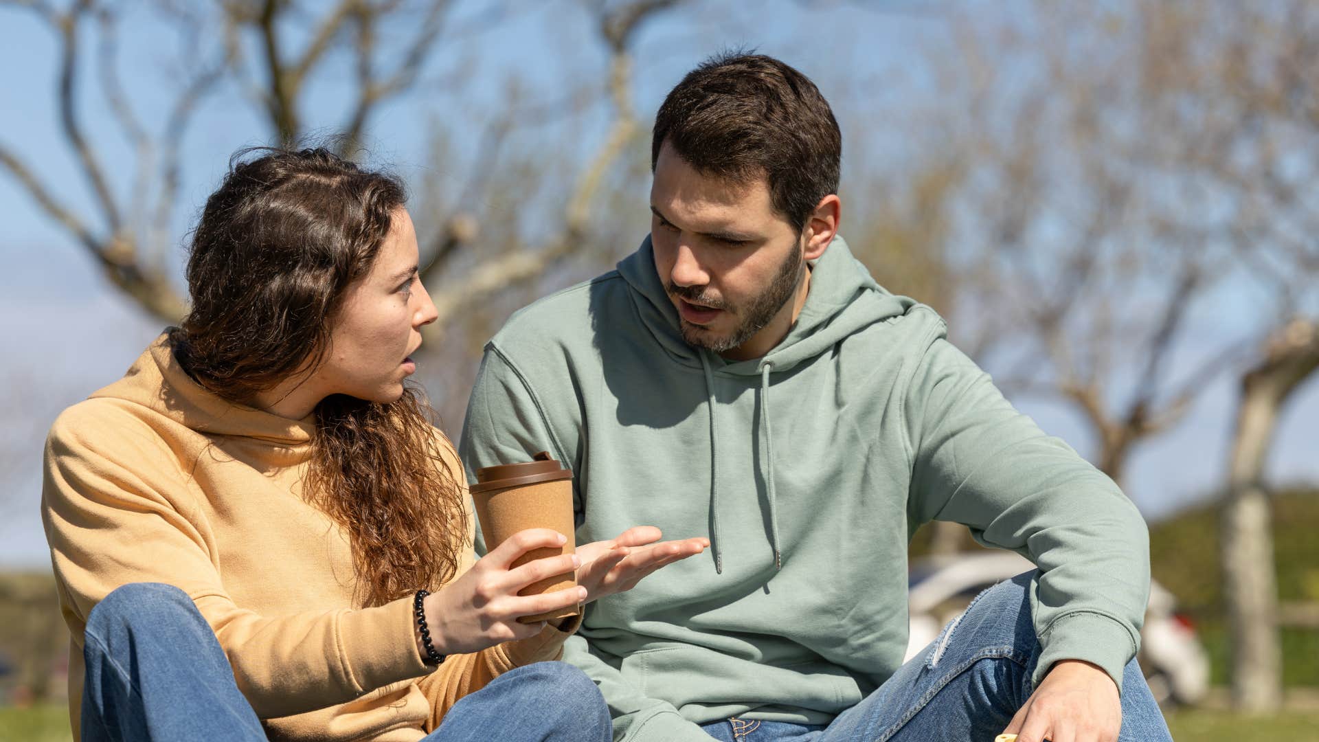woman with low mental and emotional independence asking boyfriend in the park if she's overreacting