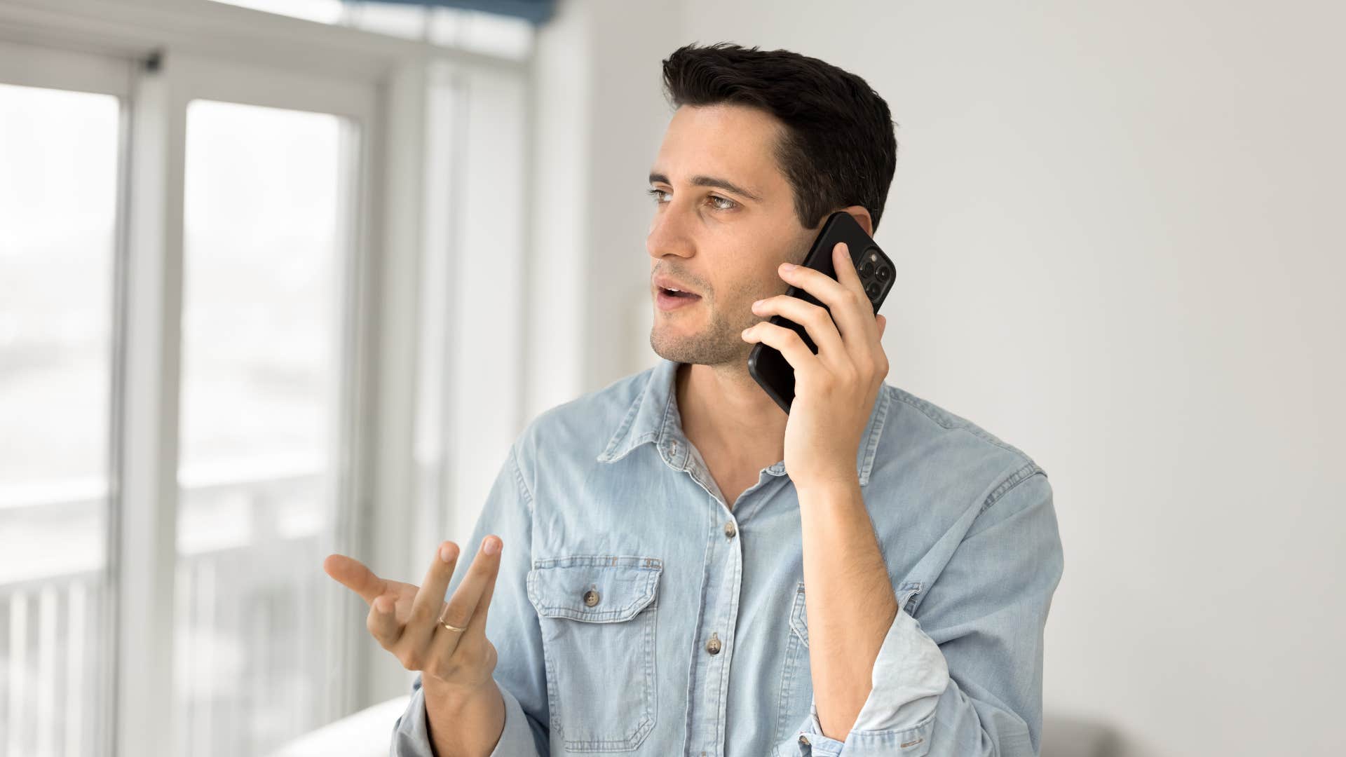 man with low mental and emotional independence telling friend on phone that he'll do whatever they want