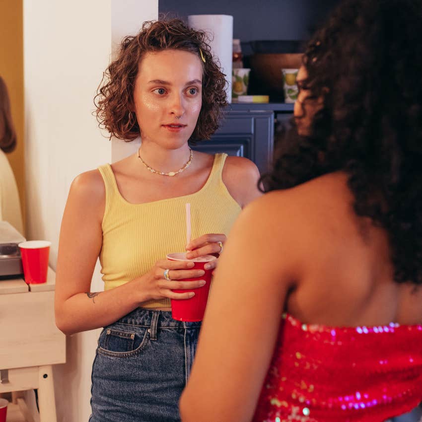 woman fishing for information at a part telling friend i know you know