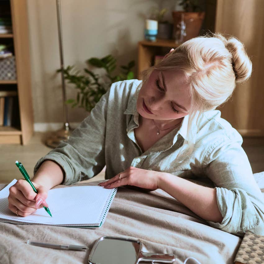 Woman writing something good is headed my way in her journal before sleep
