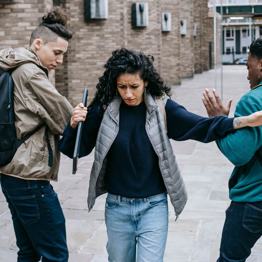 woman not wanting help pushing her friends aside