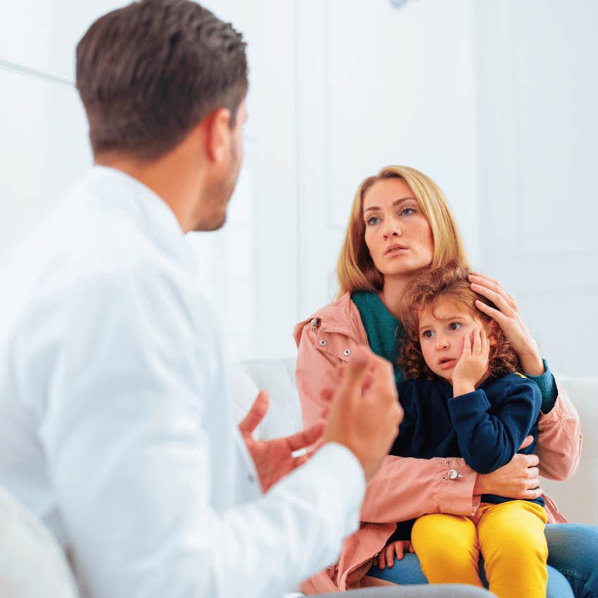 professional mom holding her child facing husband derailing her career