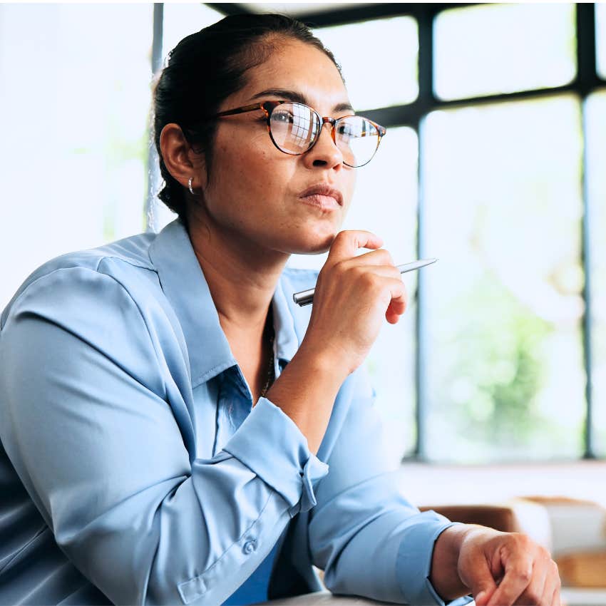 creative intelligent woman thinking thoughtfully at work