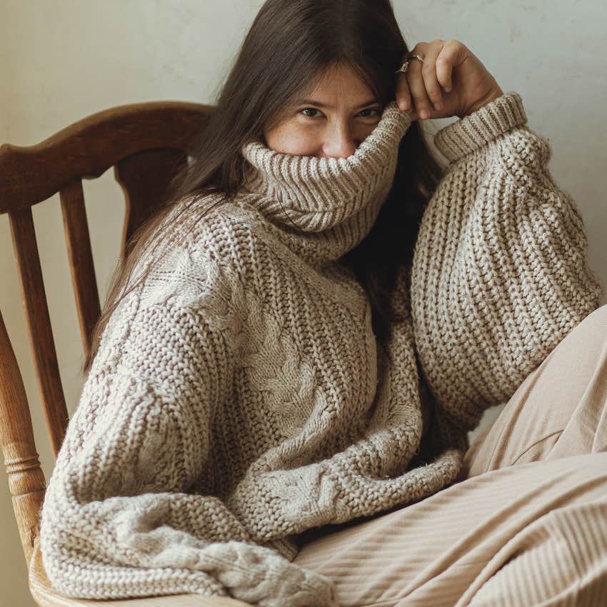 woman thrilled fall is coming snuggling into her favorite sweater