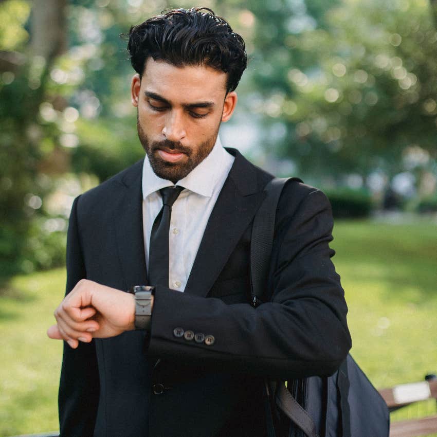impatient man looking at his watch annoyed by having to wait